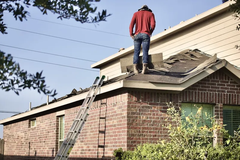 Professional roofer working on a residential roof in Calverton
